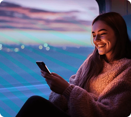 Man smiling while holding her phone