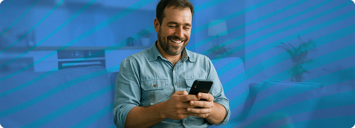 Man smiling at his phone