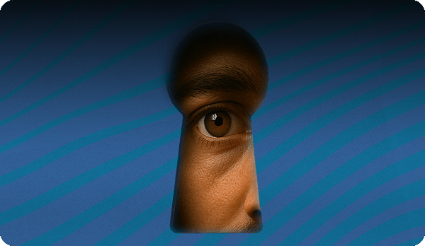 Man looking through oversized keyhole