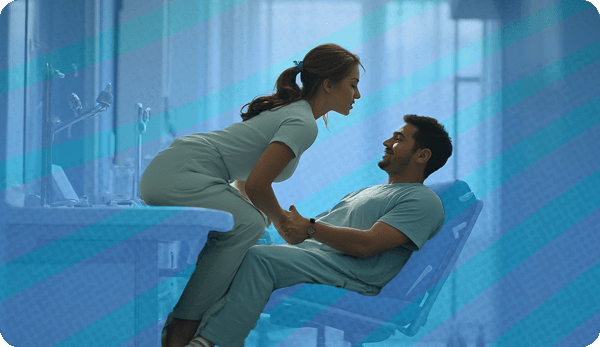 Male and female doctors flirting in exam room